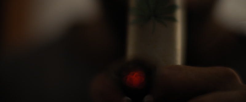 person smoking marijuana with a bong 