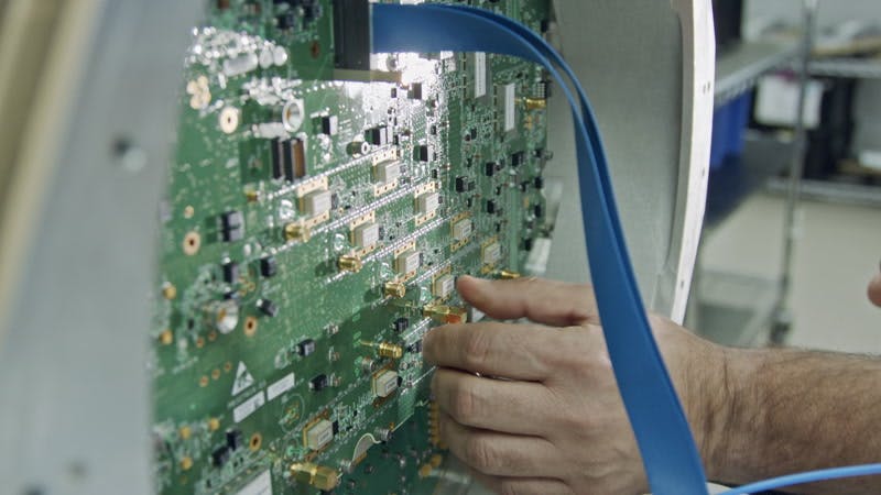 technician attaching a wire to a circuit board