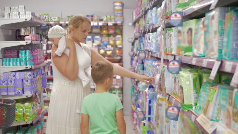 mother in the supermarket with her children 