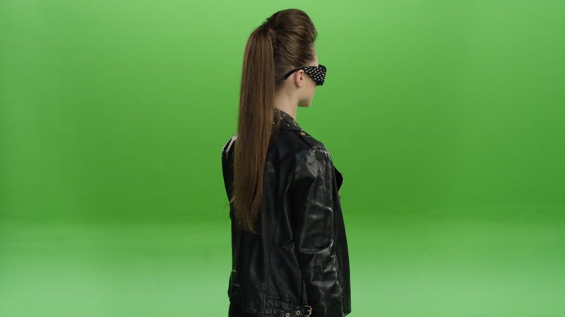 model turning wearing  a leather jacket and sunglasses green screen