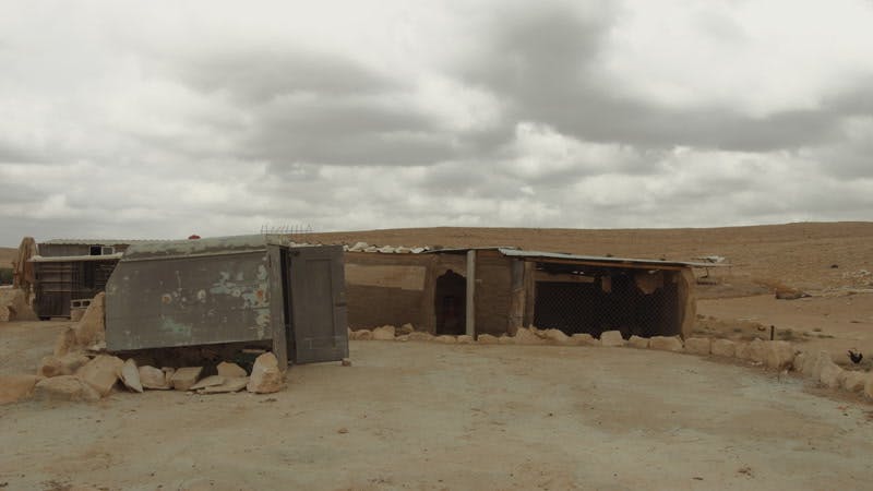 shacks in desert on cloudy day