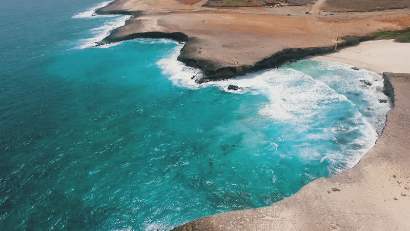Waves breaking over the sand aerial