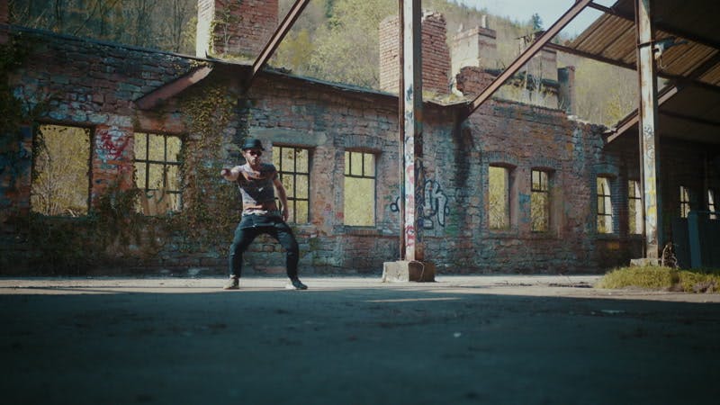 man dancing in broken down abandoned building