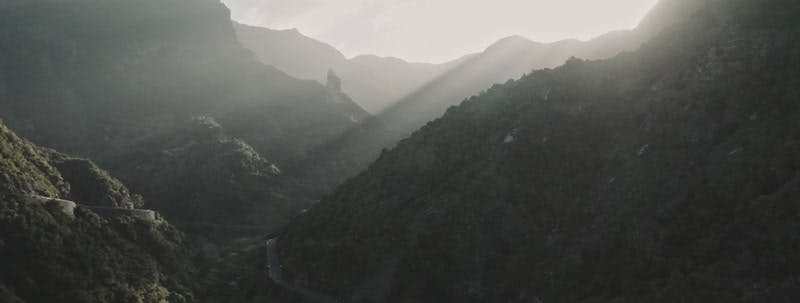 road going through a mountain valley aerial 