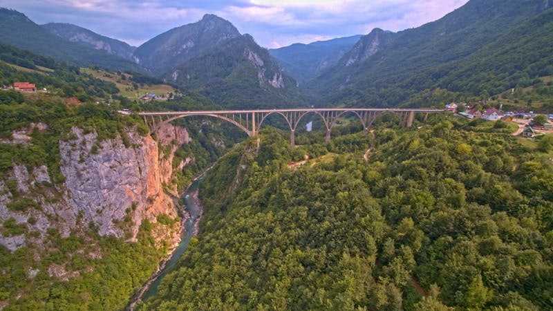 bridge crossing a valley with a river aerial 
