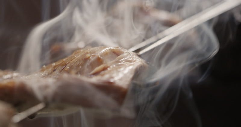steam rising from hot meat on a skewer 