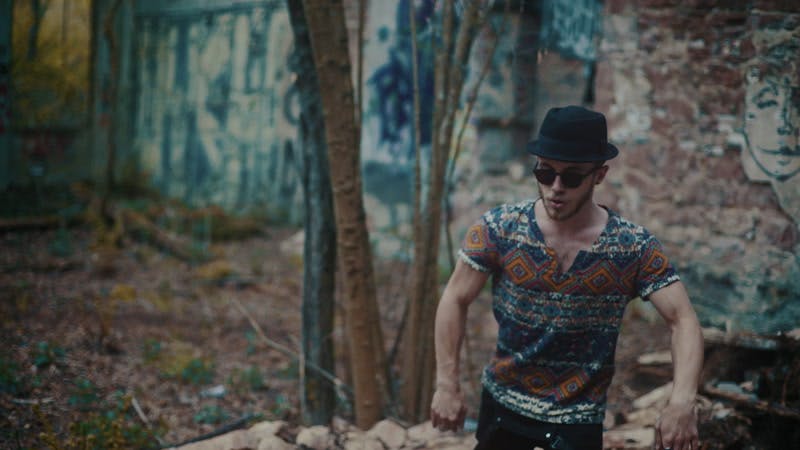 man dancing in empty building with rubble