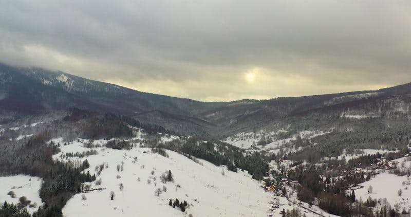 village in the snowy hills aerial 
