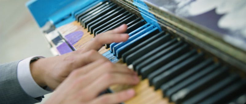man playing a colorful piano 