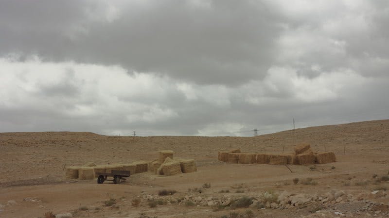 hay bales in desert on cloudy day