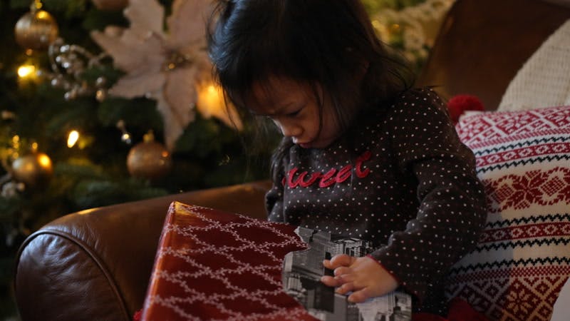 little girl opening up a present